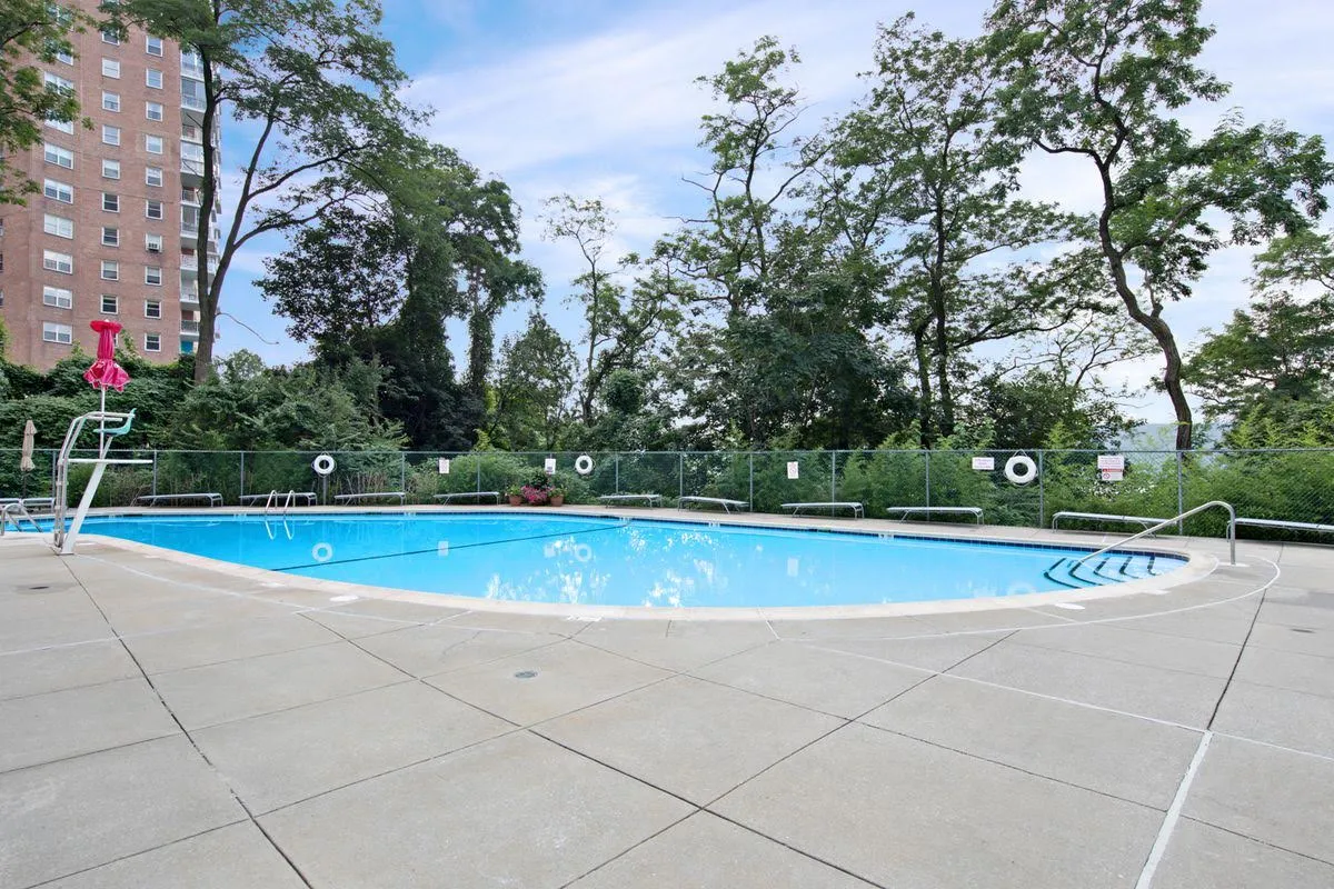 a view of swimming pool with trees in the background