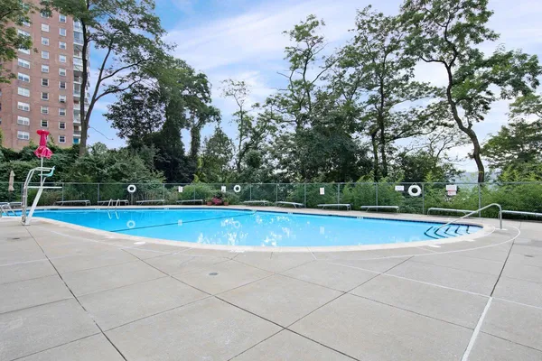 a view of swimming pool with trees in the background