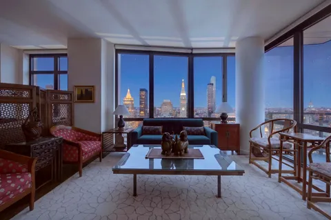 a living room with furniture a rug and a window