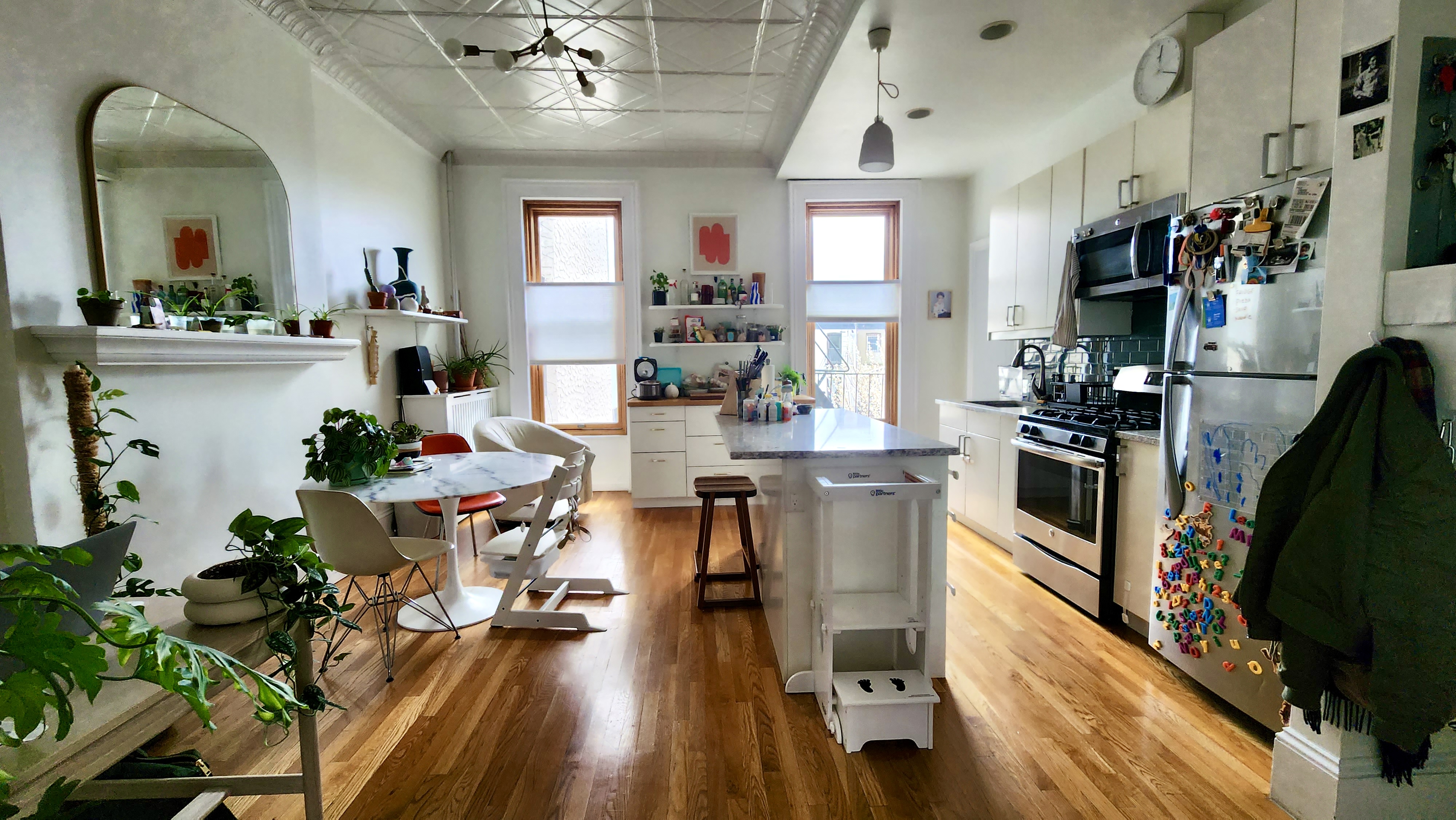 118 1st Place, Unit 2 Brooklyn, NY 11231 - Photo 2 of 12 a kitchen with stainless steel appliances a dining table chairs stove refrigerator and cabinets