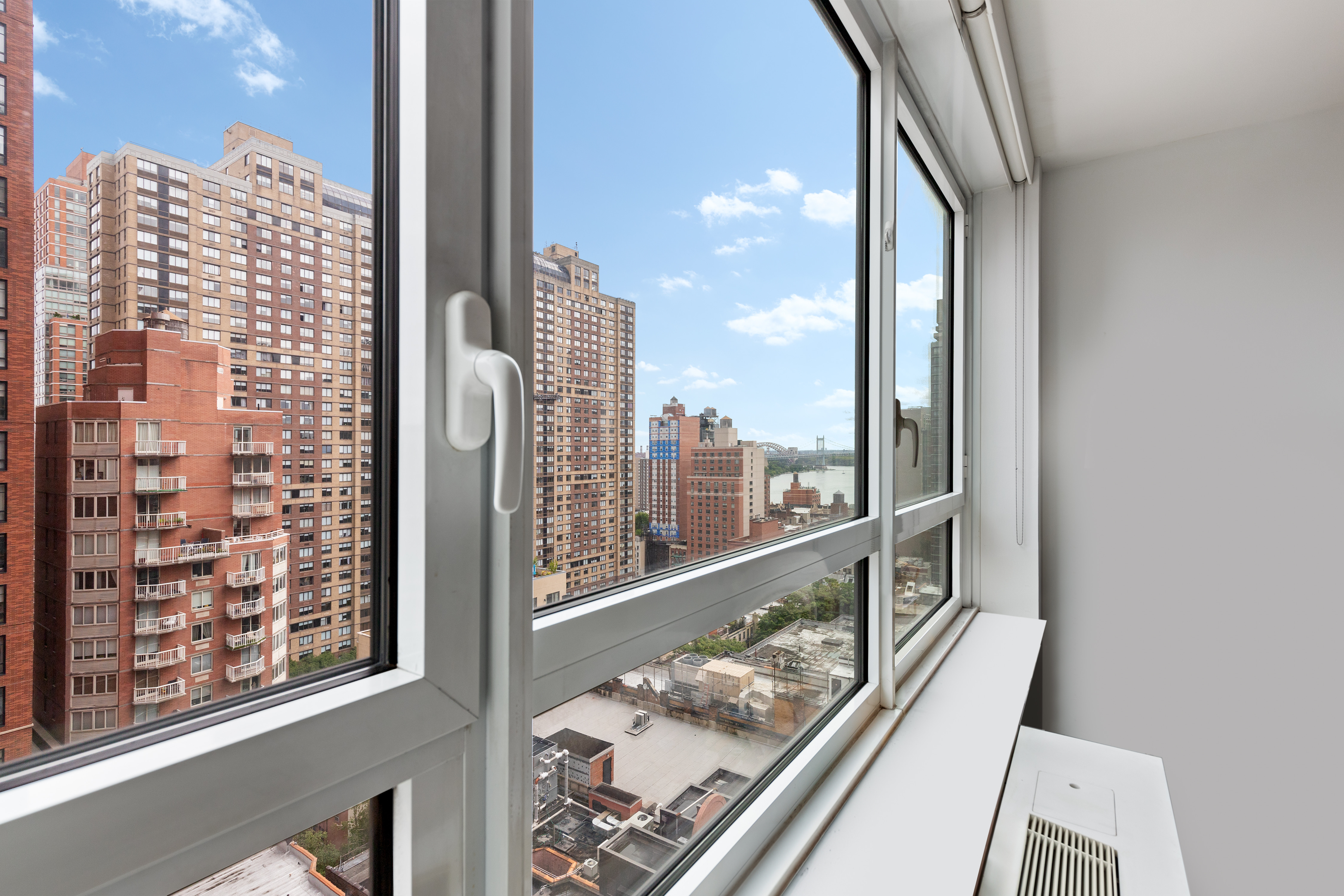 200 East 94th Street, Unit 1516 Manhattan, NY 10128 - Photo 4 of 14 a view of a balcony with couches and wooden floor