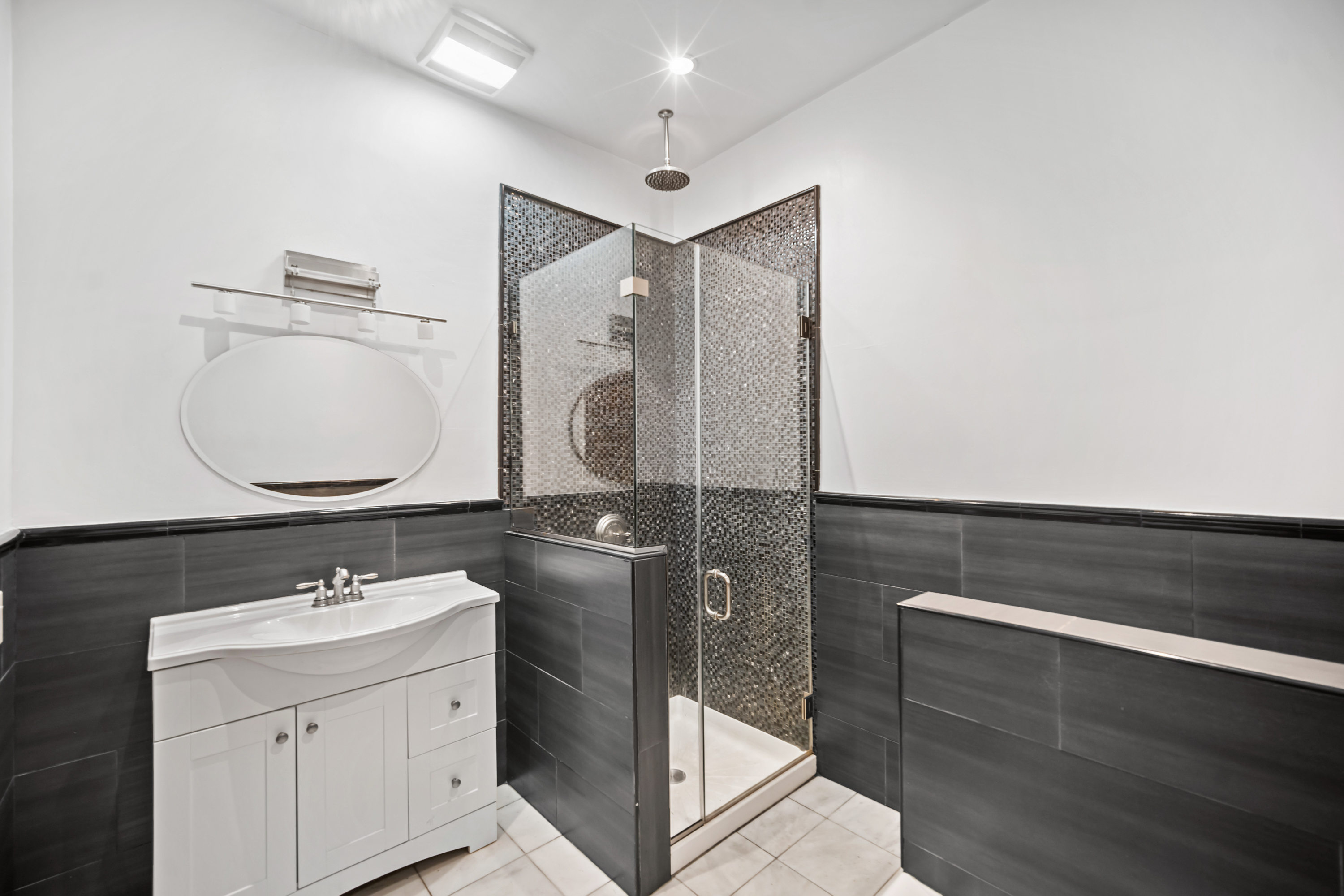 60-13 Menahan Street, Unit 1 Queens, NY 11385 - Photo 14 of 19 a bathroom with a sink mirror and vanity