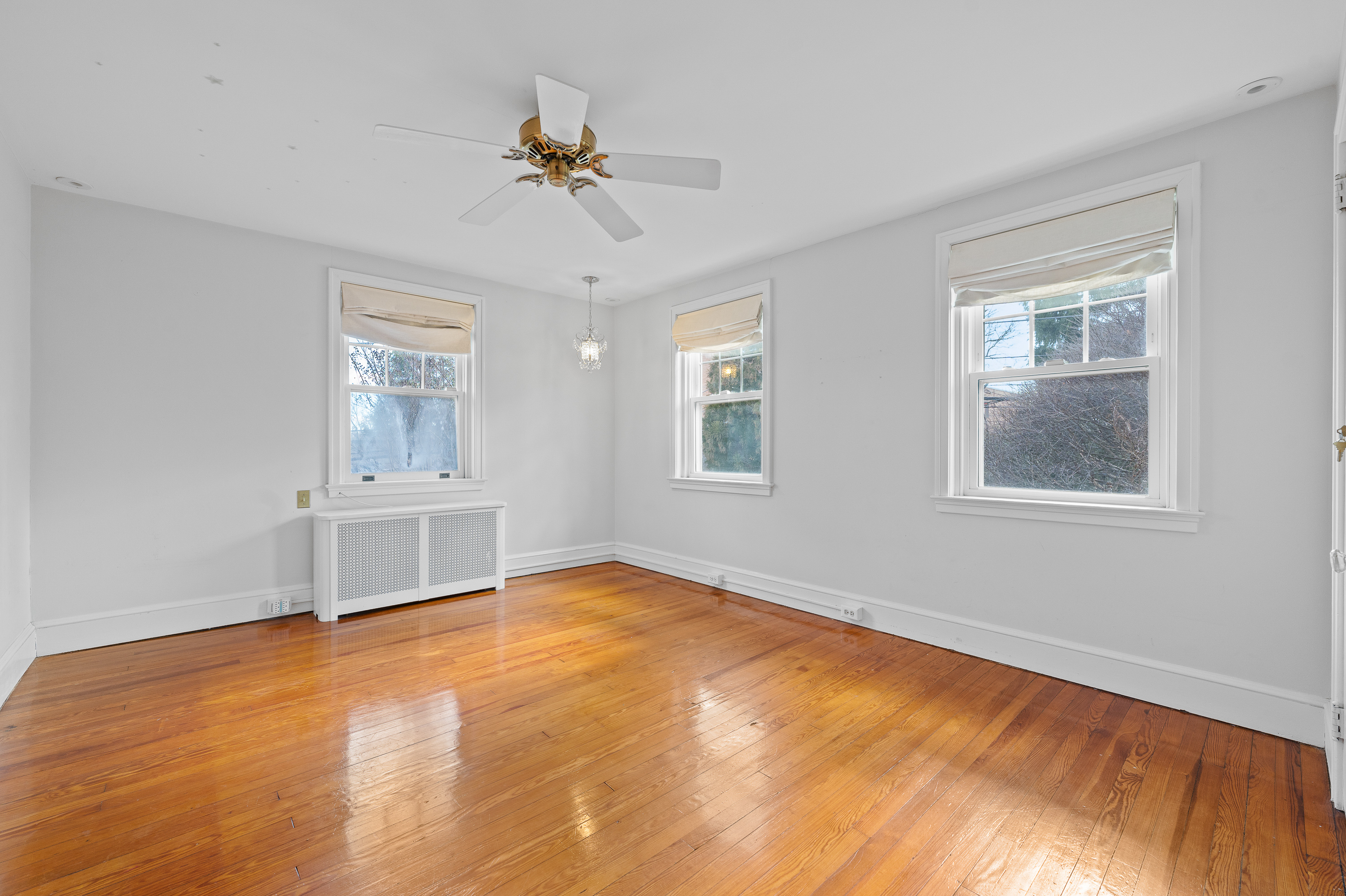 201 West Avenue Wayne, PA 19087 - Photo 15 of 26 a view of an empty room with chandelier fan and wooden floor