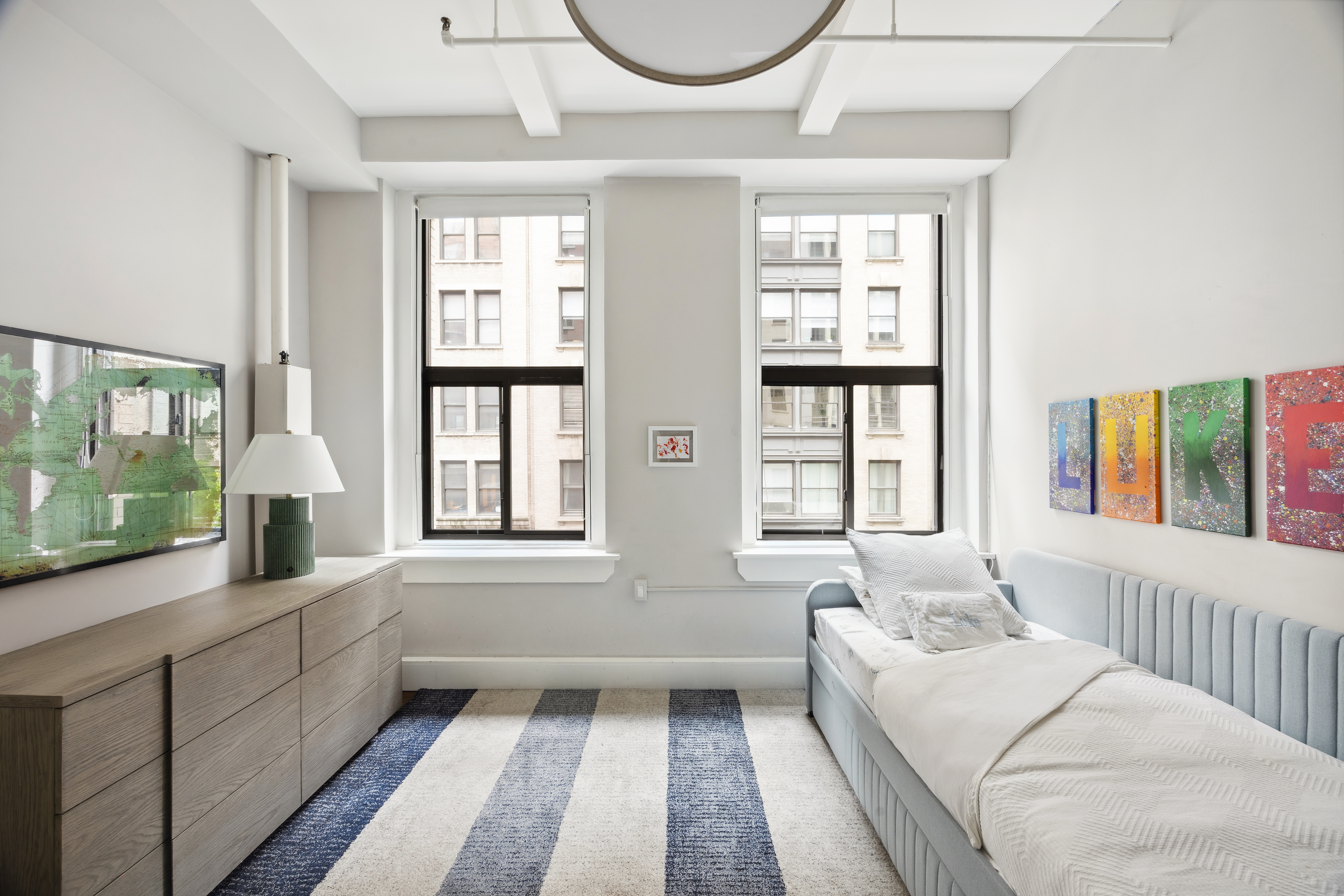 129 West 22nd Street, Unit 5A Manhattan, NY 10011 - Photo 9 of 13 a living room with furniture and windows