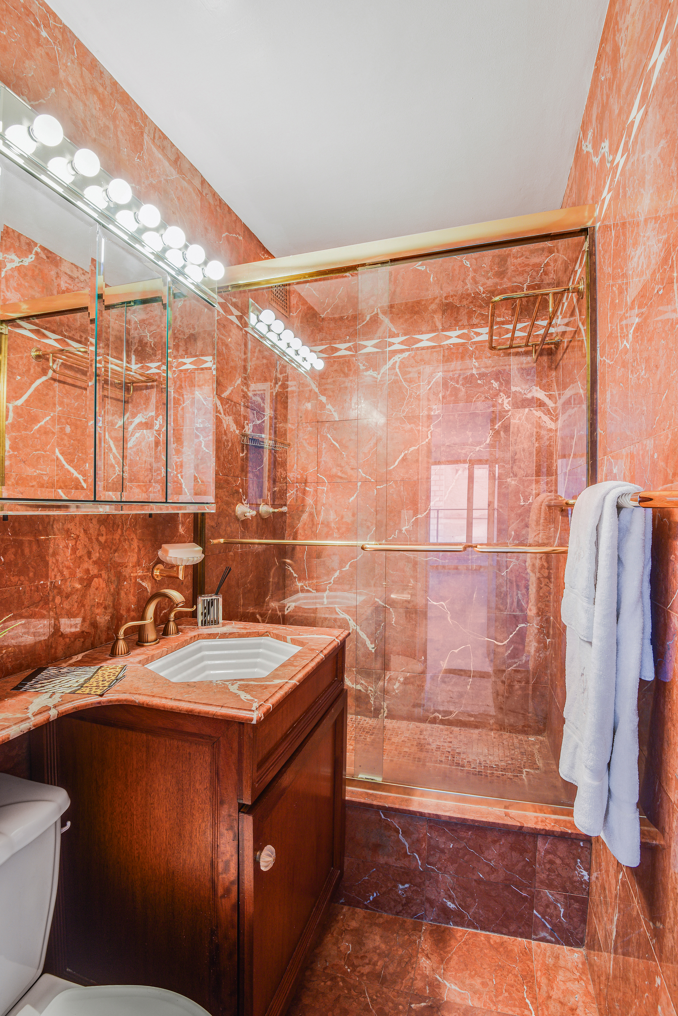 200 Central Park South, Unit 14B Manhattan, NY 10019 - Photo 16 of 17 a bathroom with a sink and a mirror