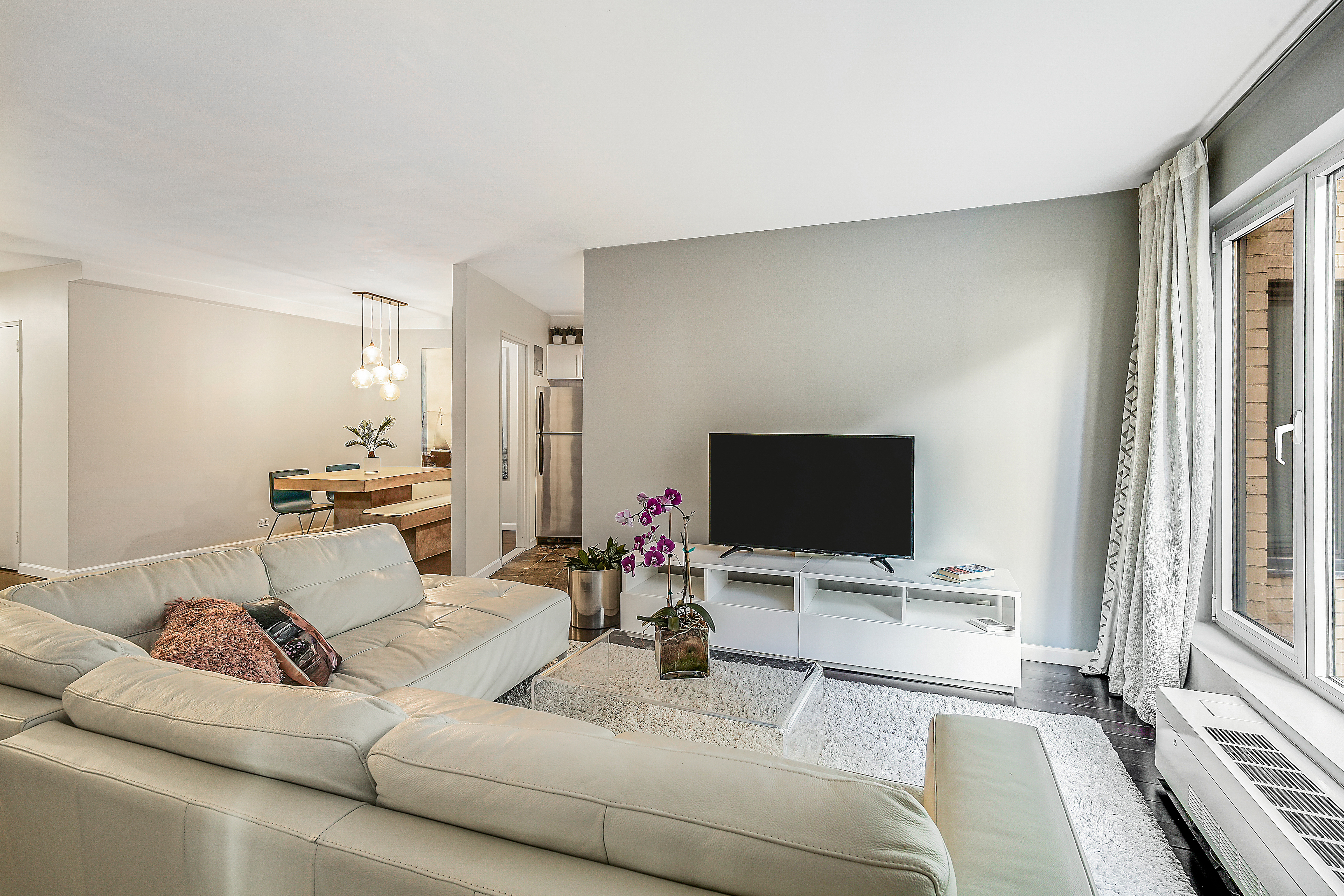 200 Central Park South, Unit 3F Manhattan, NY 10019 - Photo 8 of 9 a living room with furniture and a flat screen tv