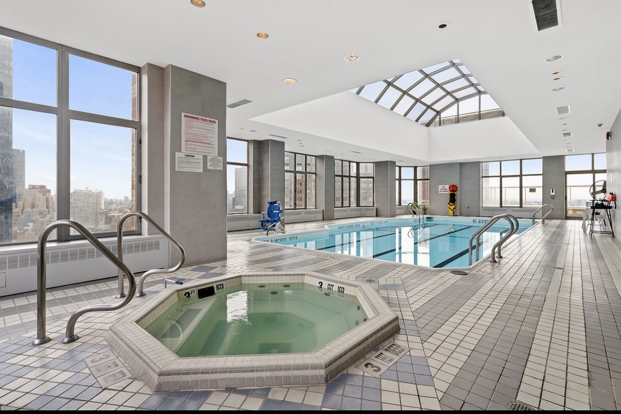 500 West 43rd Street, Unit 4E Manhattan, NY 10036 - Photo 10 of 11 a room with gym equipment and large windows