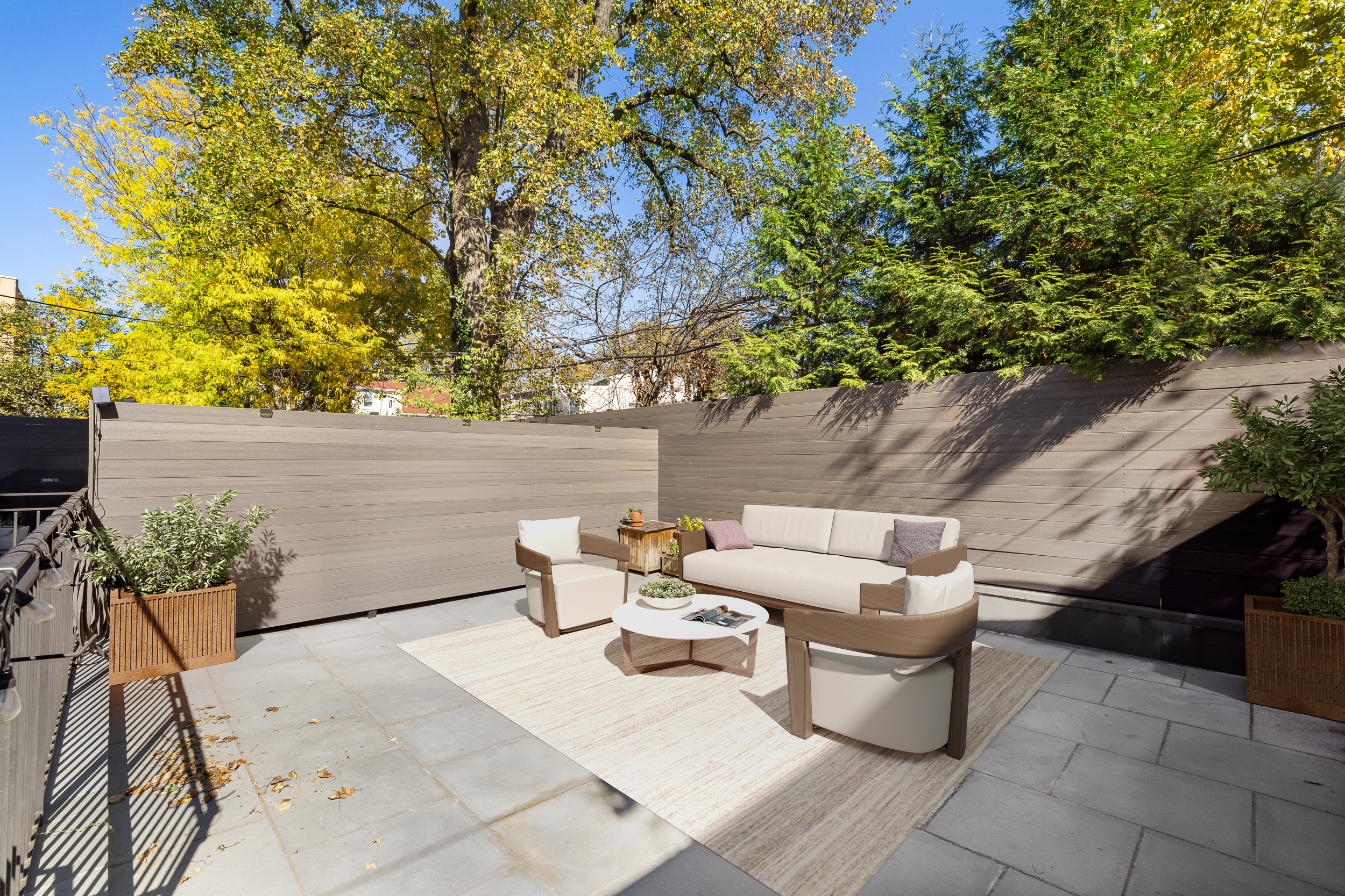 49 East 4th Street Brooklyn, NY 11218 - Photo 4 of 16 a backyard of a house with table and chairs