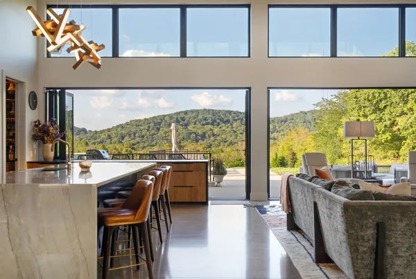 a living room with large window and a flat screen tv