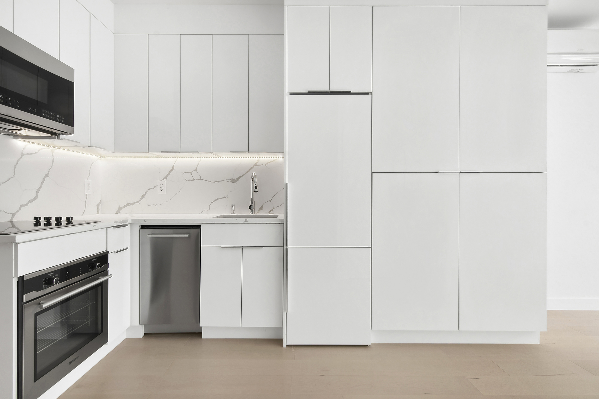 a kitchen with a stove and white cabinets