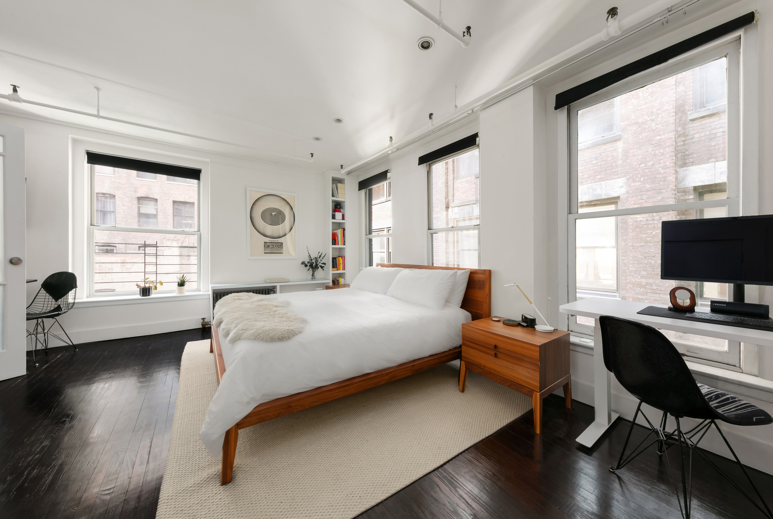 133-131 West 28th Street, Unit 6C Manhattan, NY 10001 - Photo 6 of 10 a bedroom with a bed and a desk