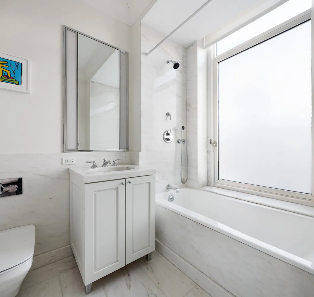 a bathroom with a sink a toilet and a bathtub