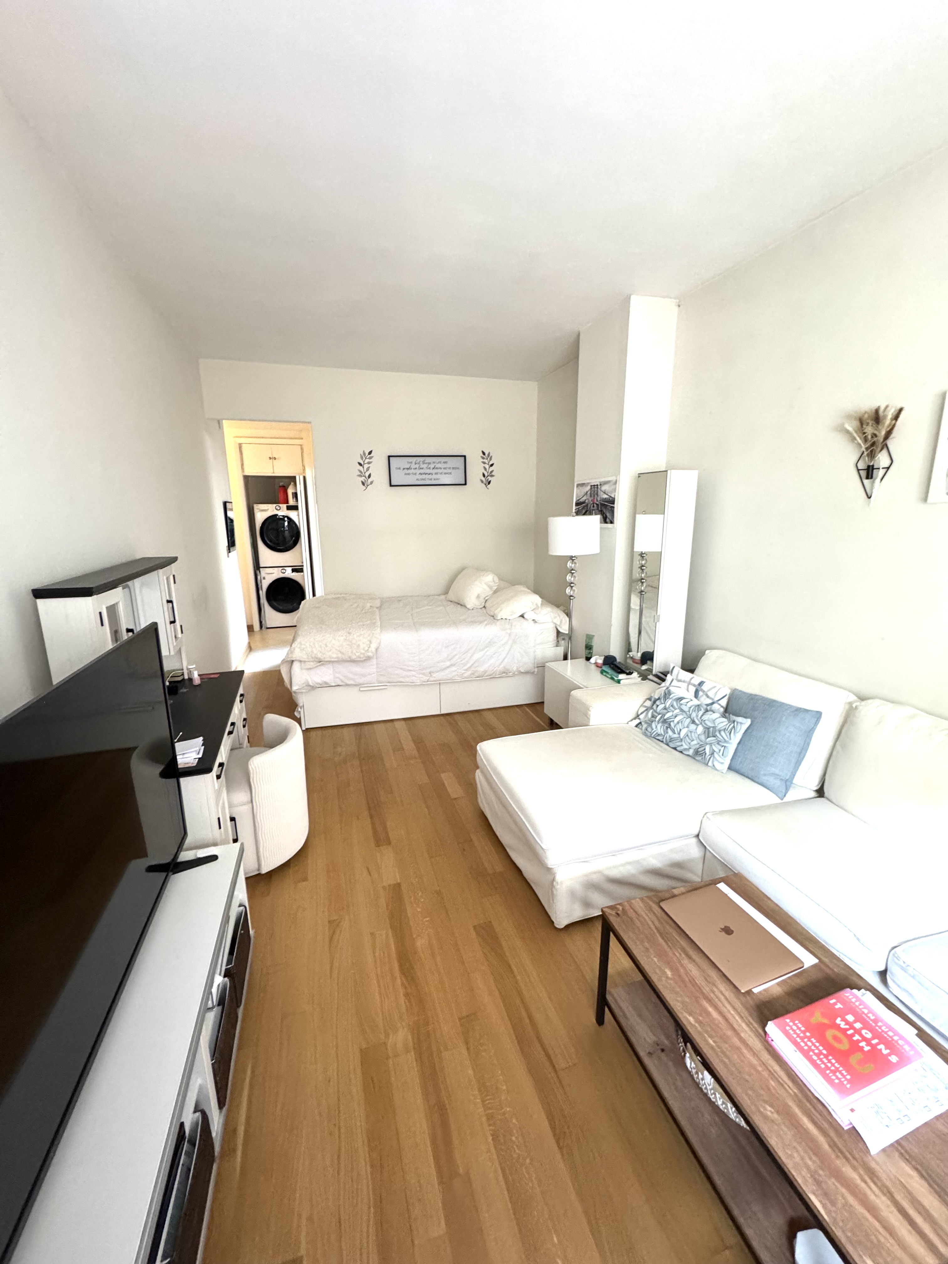 61 East 77th Street, Unit 7E Manhattan, NY 10075 - Photo 6 of 10 a living room with a couch and a table