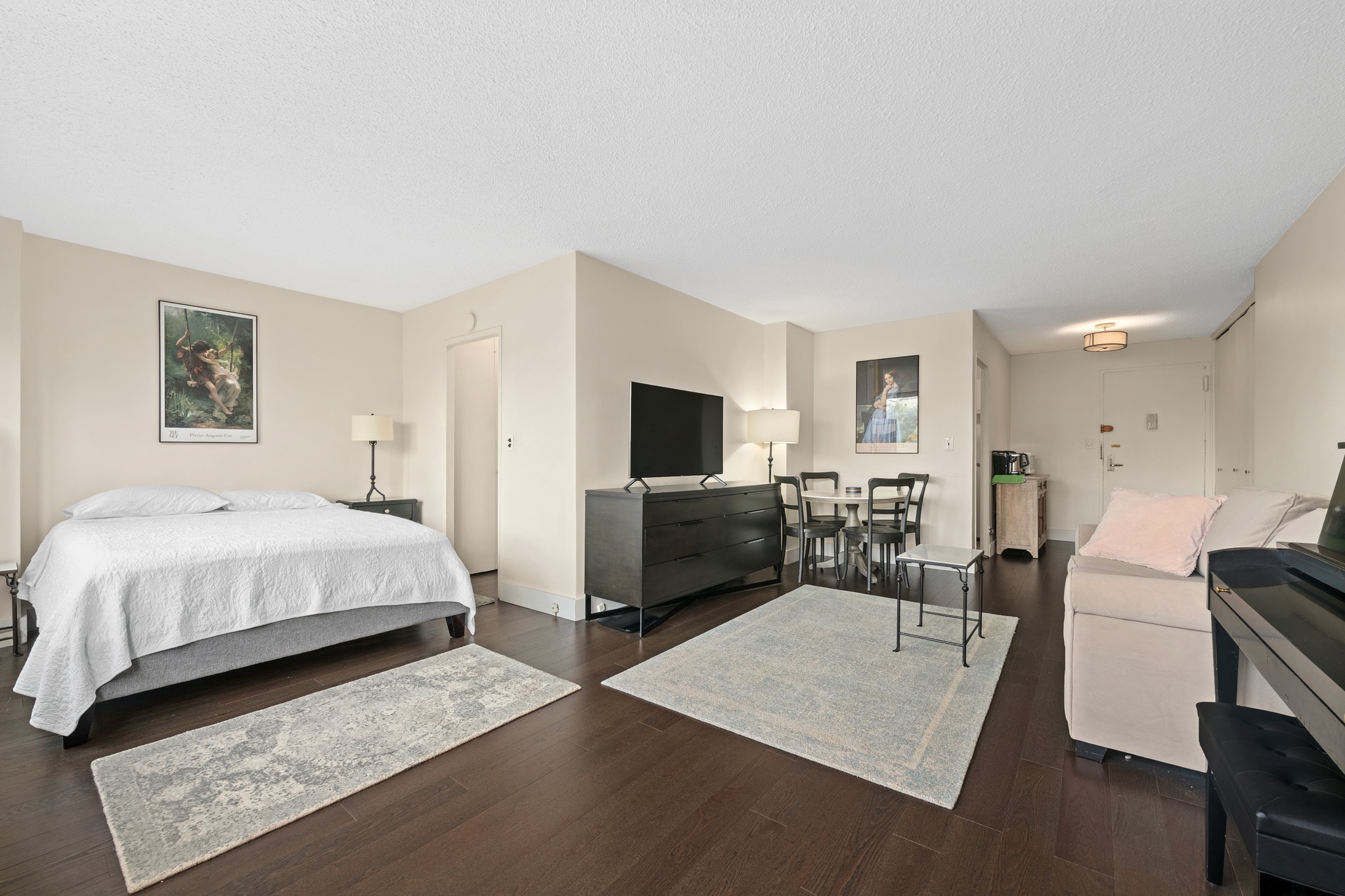 230 East 15th Street, Unit 7P Manhattan, NY 10003 - Photo 2 of 8 a bedroom with a bed and a flat screen tv