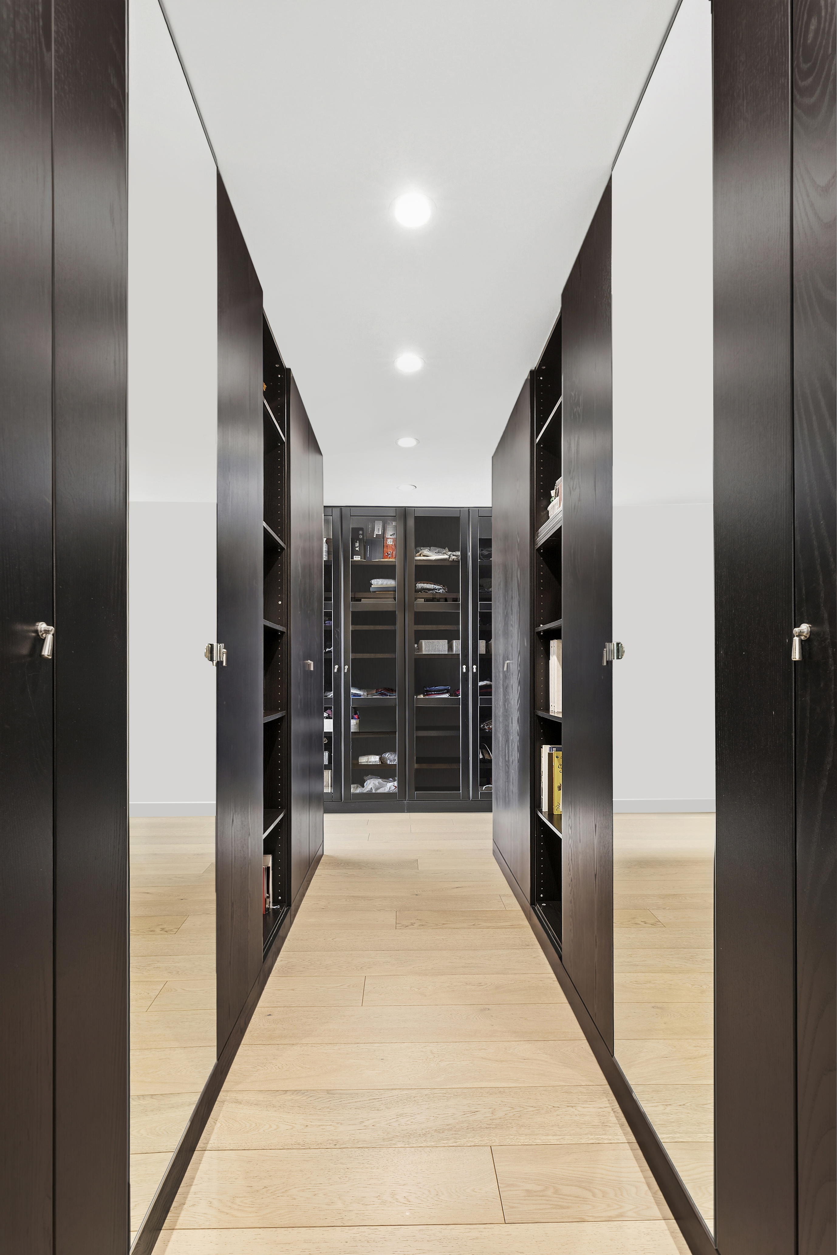 21 South End Avenue, Unit 402 Manhattan, NY 10280 - Photo 7 of 13 a view of a hallway with wooden shelves