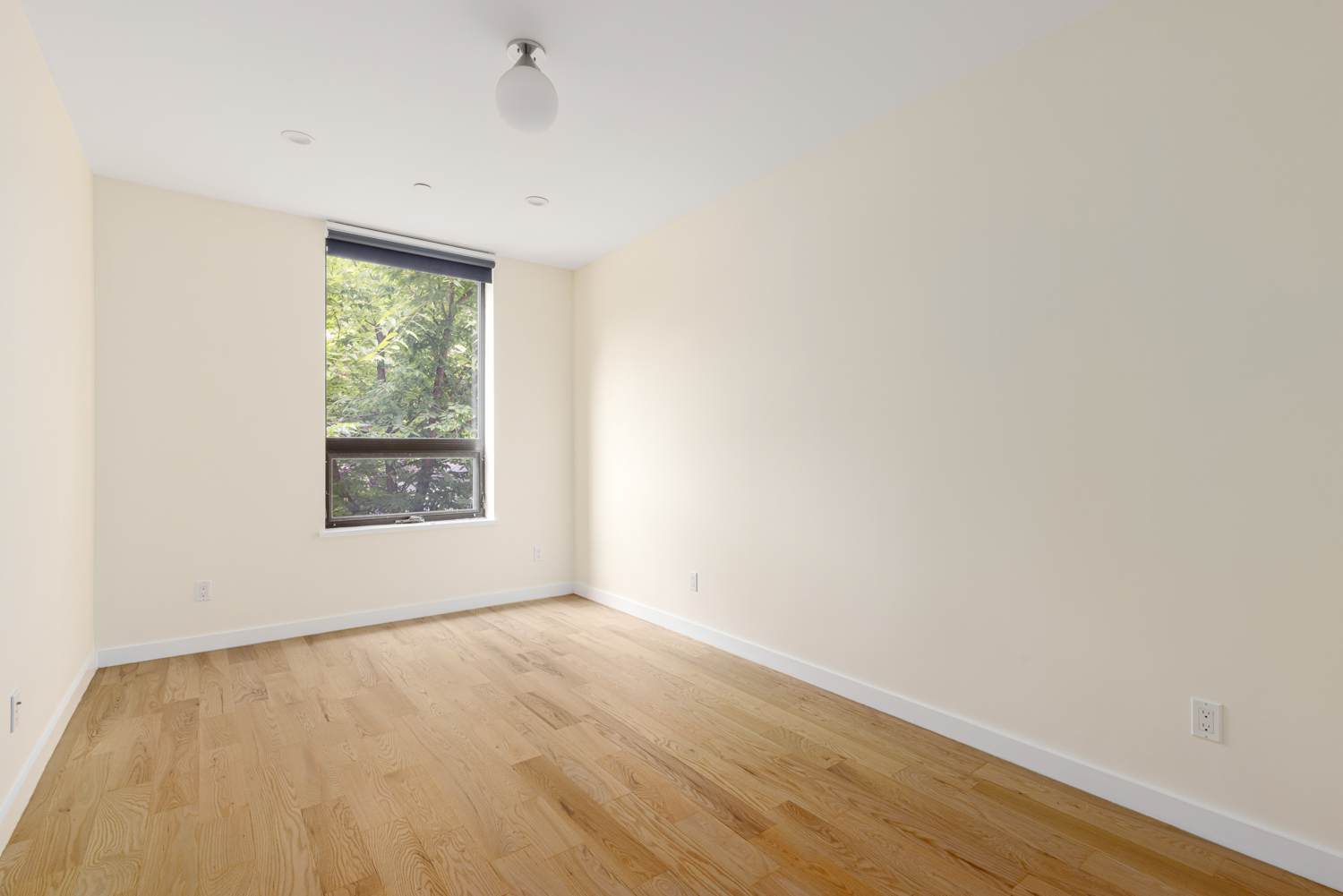 74 Adelphi Street, Unit 2B Brooklyn, NY 11205 - Photo 6 of 9 a view of an empty room with wooden floor and a window