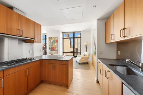 a kitchen with a sink and a stove top oven