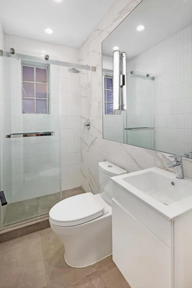 a bathroom with a toilet sink and shower