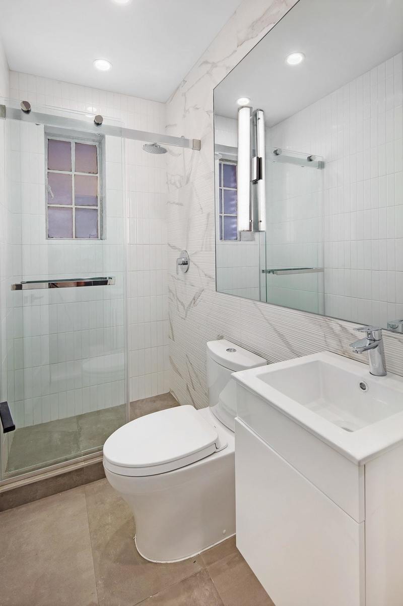 72 Bedford Street, Unit 3A Manhattan, NY 10014 - Photo 4 of 6 a bathroom with a toilet sink and shower