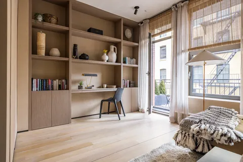 a bed room with a bed and a book shelf