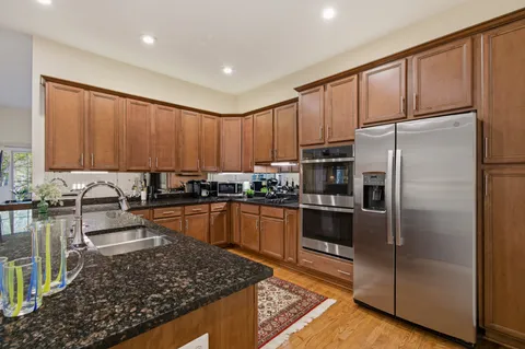 a kitchen with refrigerator and stove