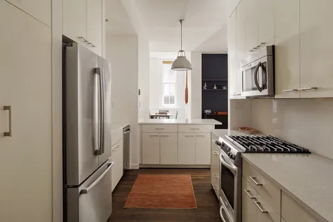 a kitchen with a refrigerator and a sink