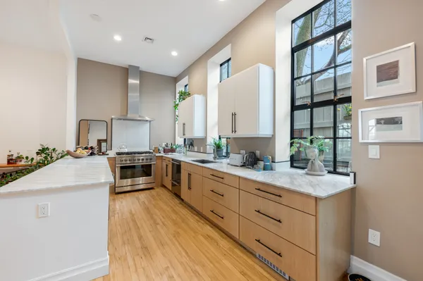 a kitchen with granite countertop a sink counter top space and cabinets