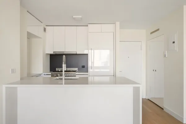 a view of kitchen with sink refrigerator and microwave