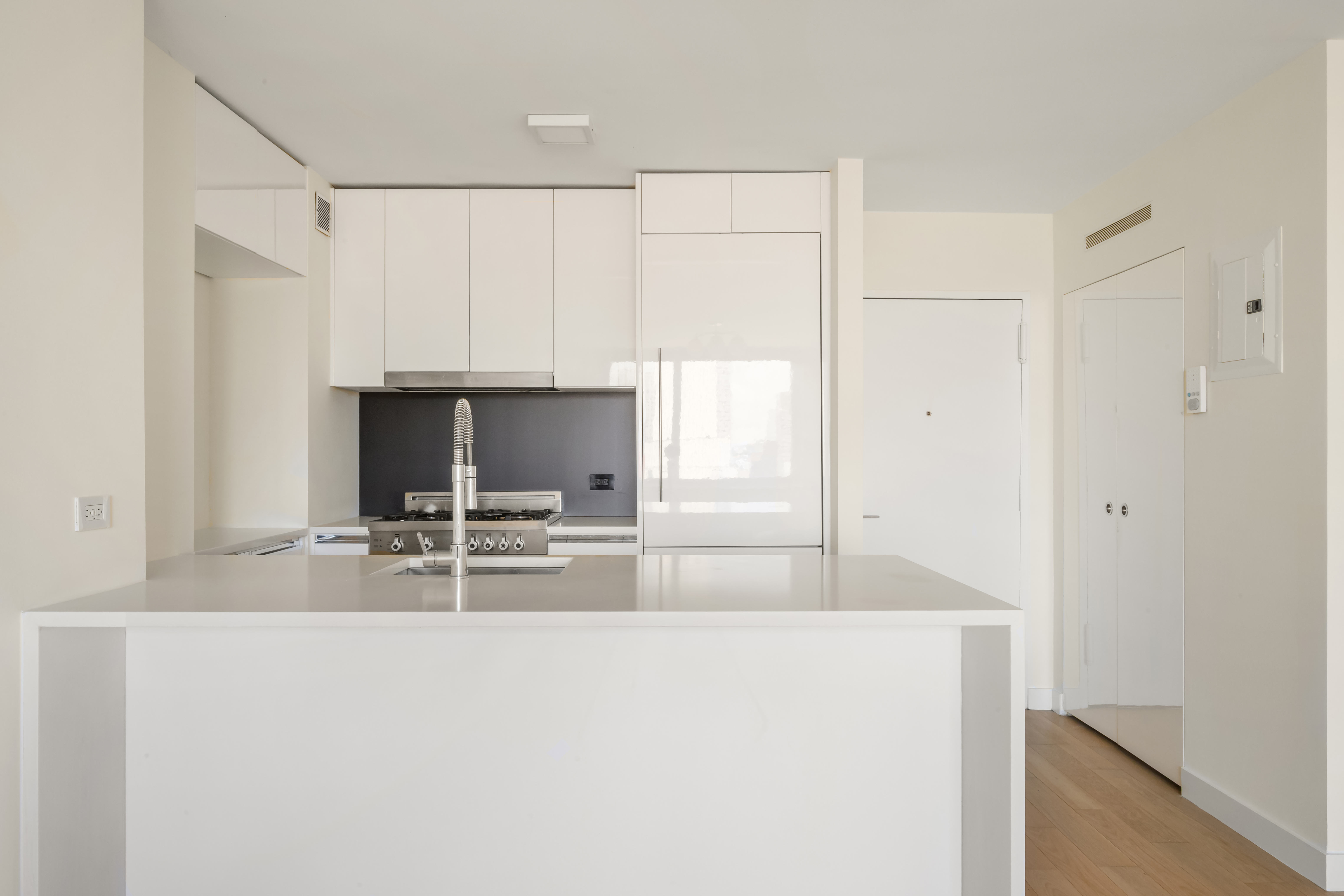 301 West 53rd Street, Unit 13C Manhattan, NY 10019 - Photo 5 of 13 a view of kitchen with sink refrigerator and microwave
