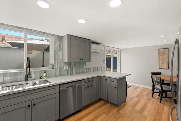 a kitchen with a sink cabinets and wooden floor