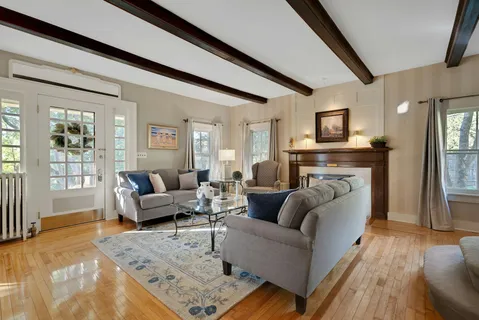 a view of a livingroom with furniture front door and a window
