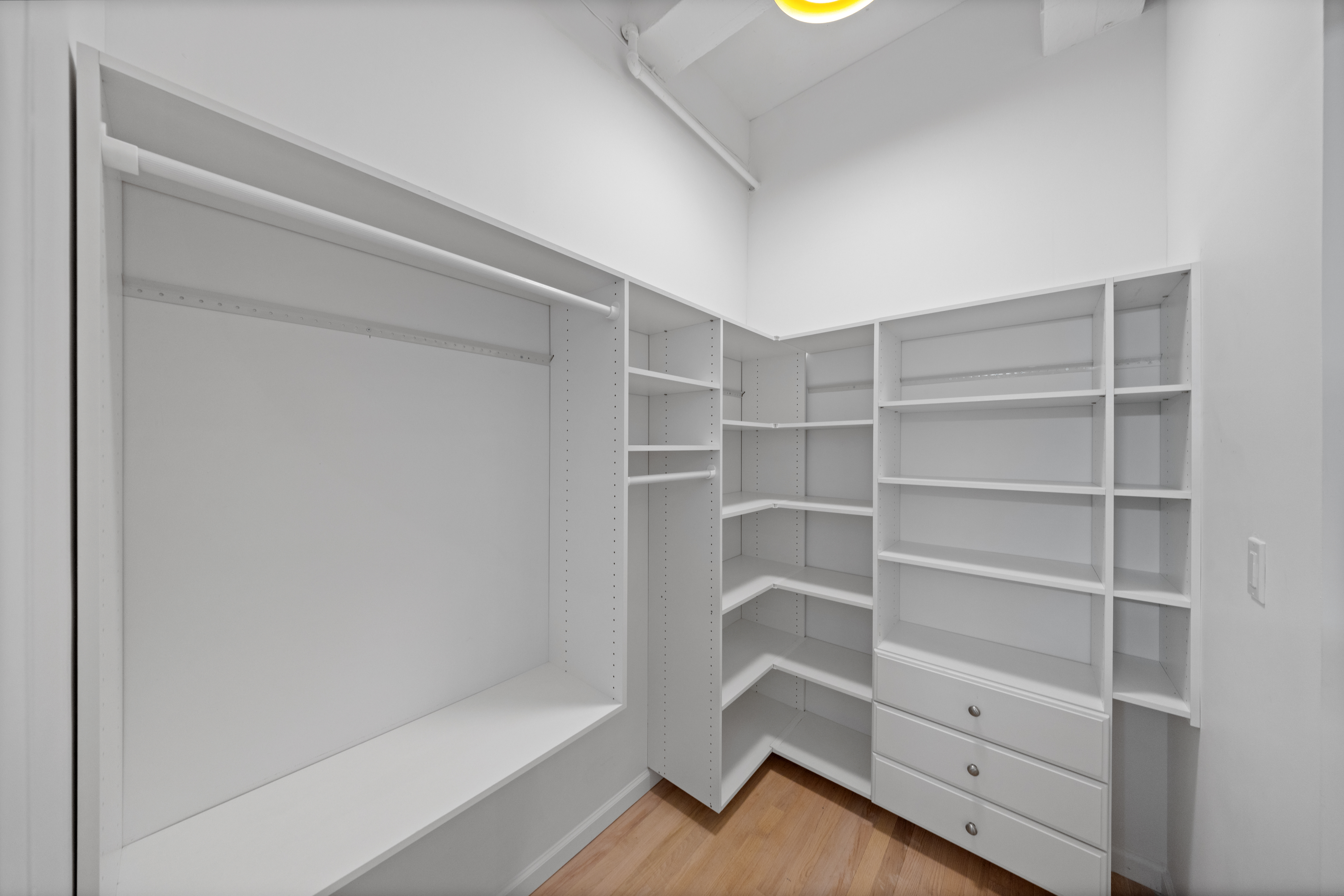 95 Vandam Street, Unit 2R Manhattan, NY 10013 - Photo 14 of 21 a view of walk in closet with empty racks