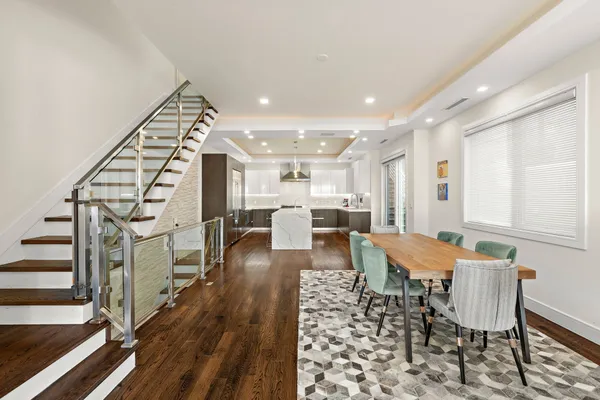 a dining room with furniture and wooden floor