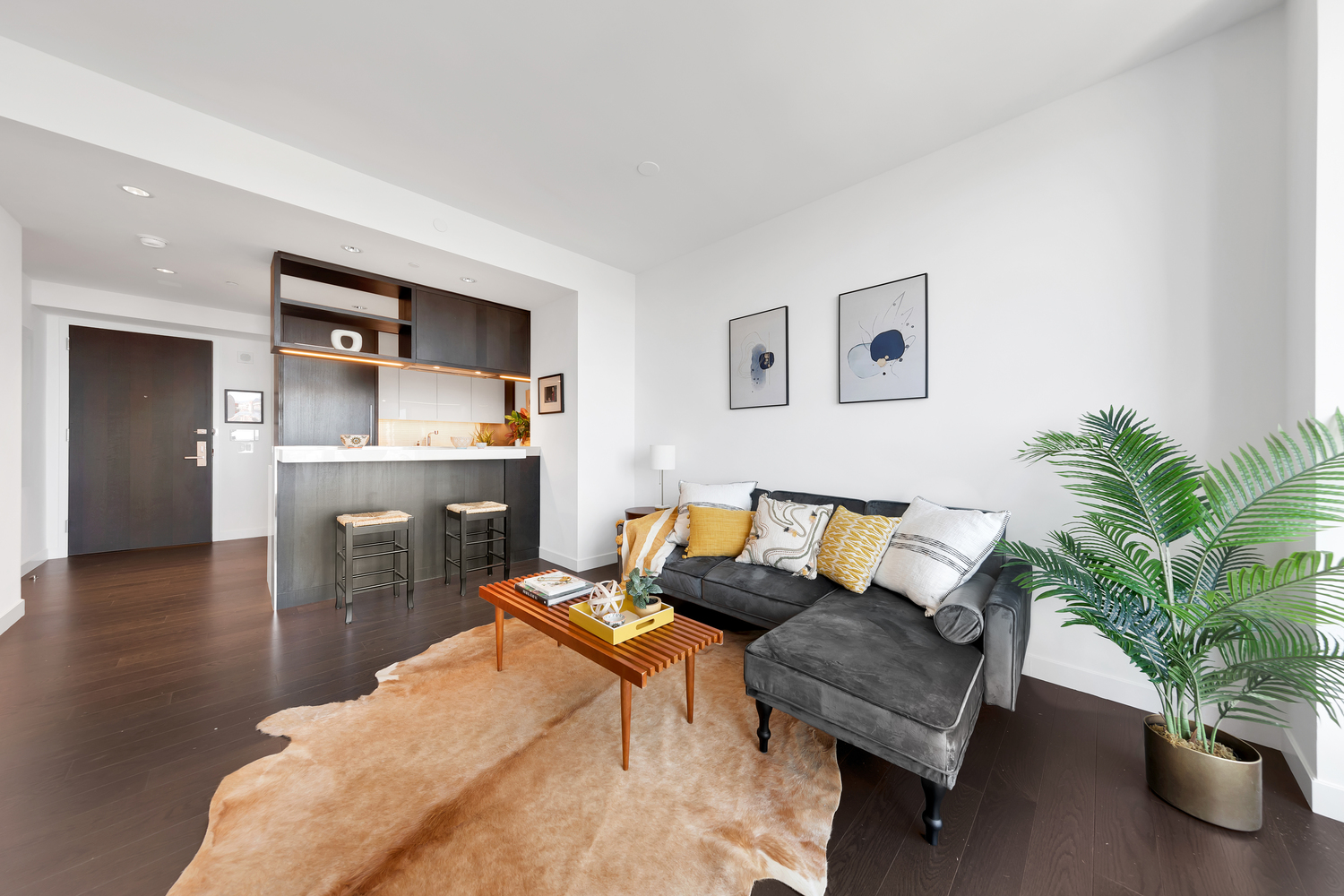 252 South Street, Unit 53E Manhattan, NY 10002 - Photo 2 of 17 a living room with furniture and a wooden floor