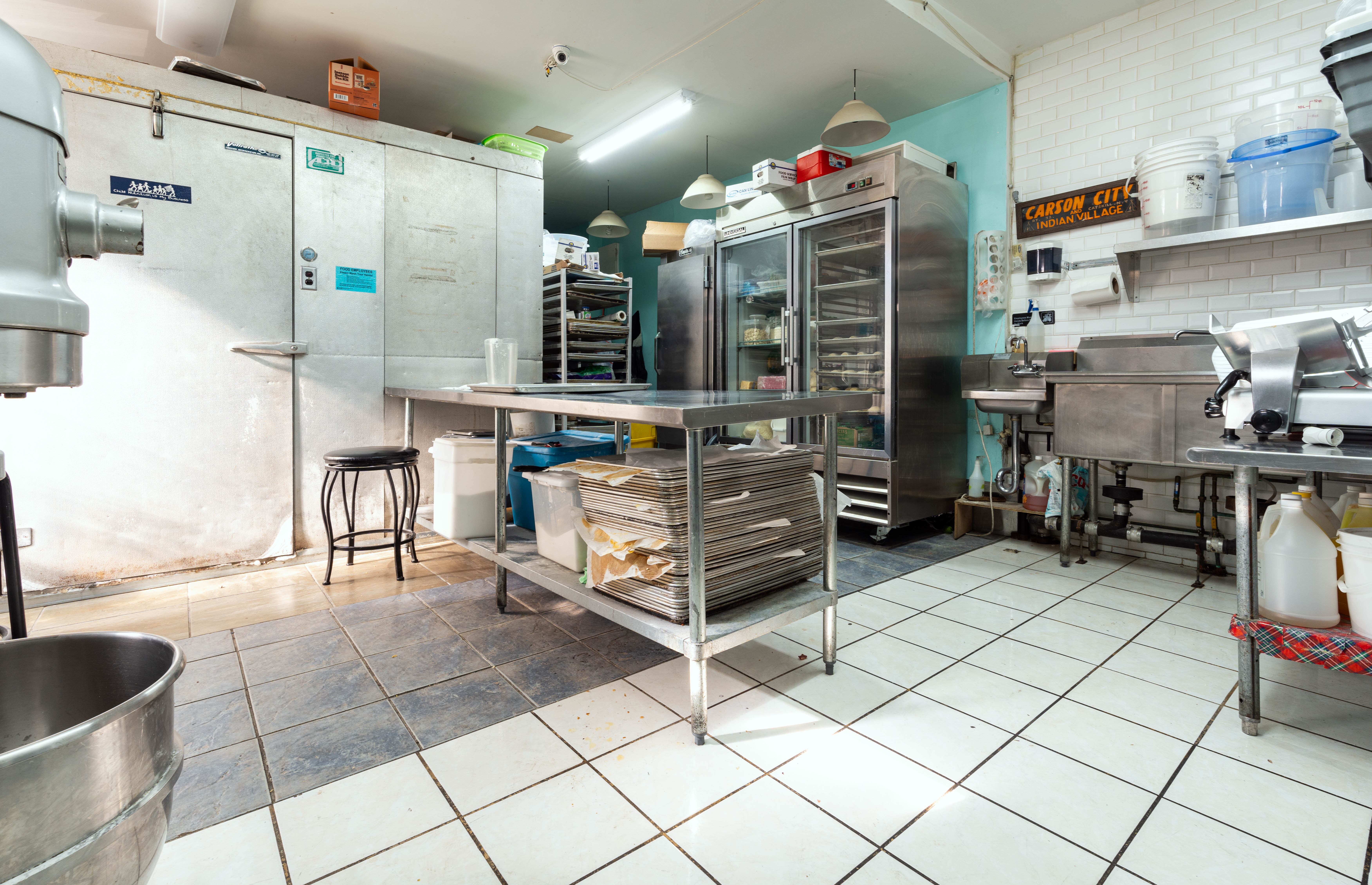 936 Seneca Avenue Queens, NY 11385 - Photo 3 of 12 a kitchen with stainless steel appliances kitchen island granite countertop a sink and cabinets