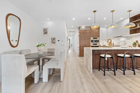 a dining table chairs and a kitchen view