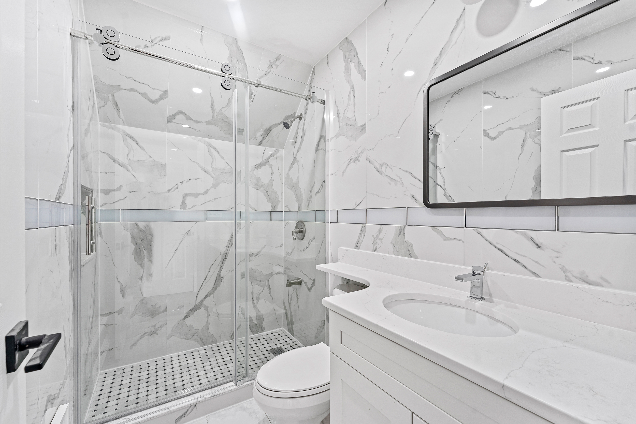 65 Bay 23rd Street, Unit 3 Brooklyn, NY 11214 - Photo 8 of 11 a bathroom with a sink a toilet and shower