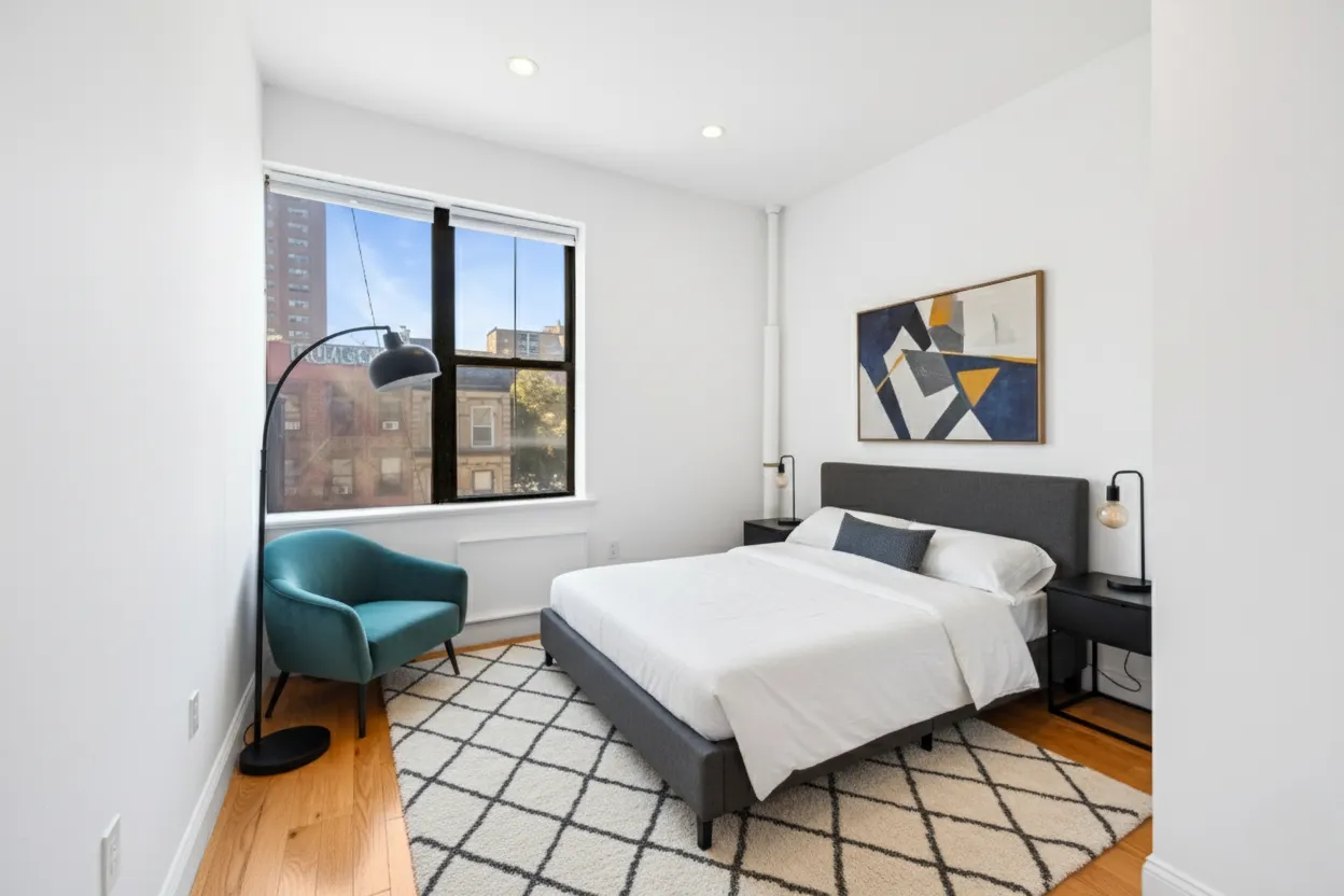 a bedroom with a bed and a painting on the wall