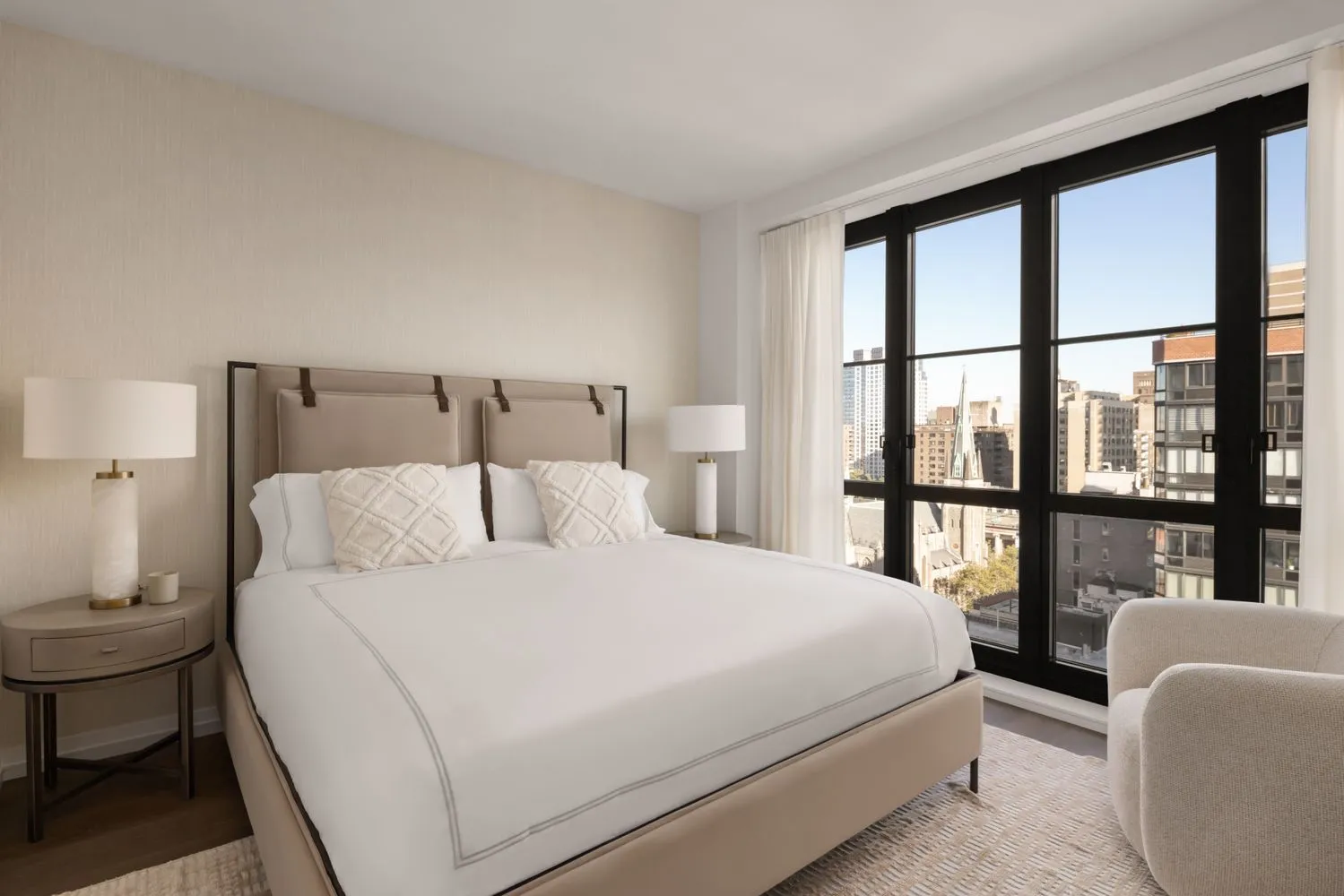 a bedroom with a large bed and a large window