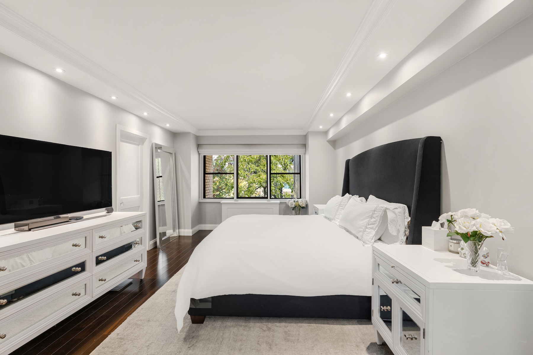 178 East 80th Street, Unit 3A Manhattan, NY 10075 - Photo 5 of 14 a spacious bedroom with a bed and a flat screen tv
