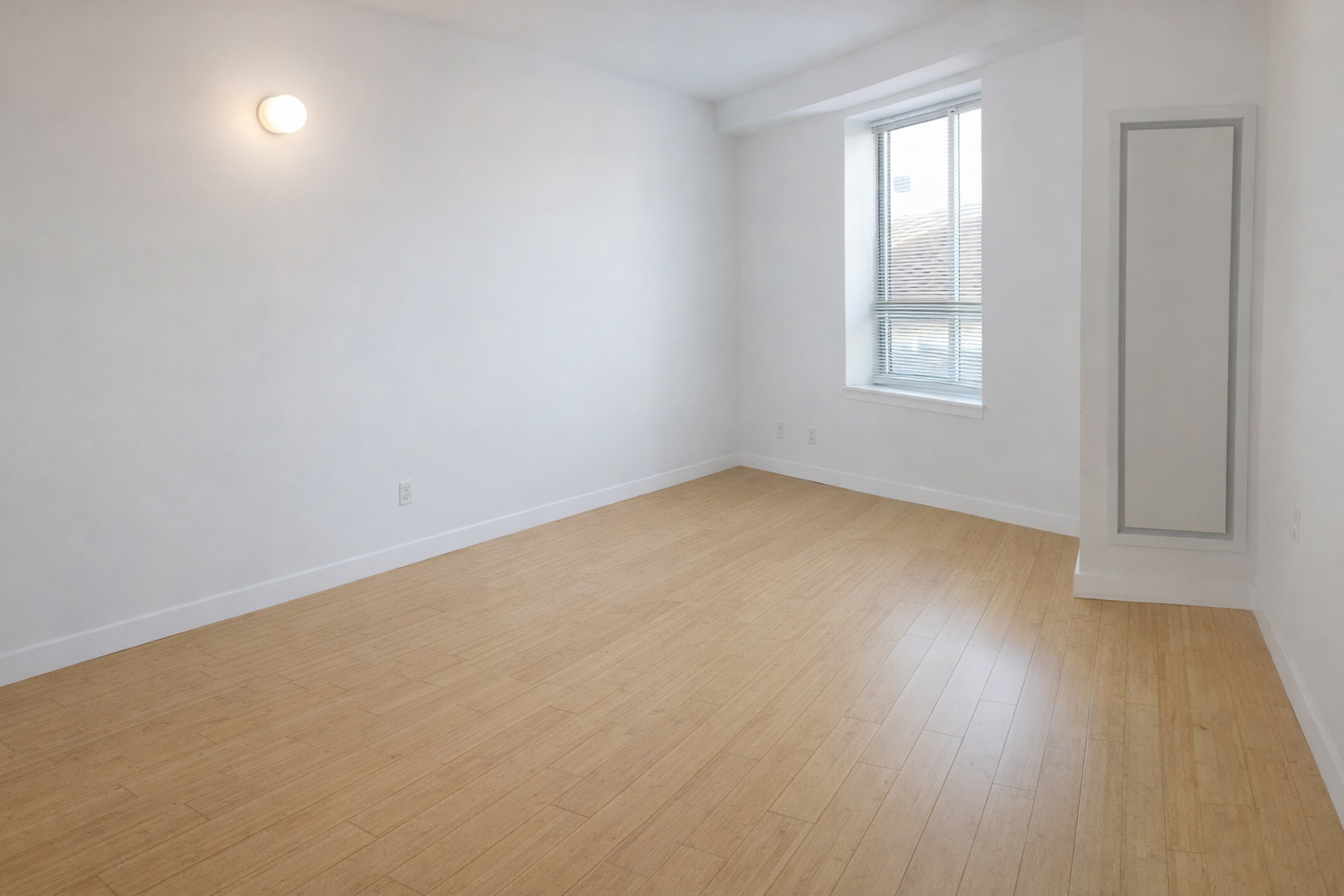 212 South Oxford Street, Unit 7K Brooklyn, NY 11217 - Photo 7 of 16 an empty room with wooden floor and windows