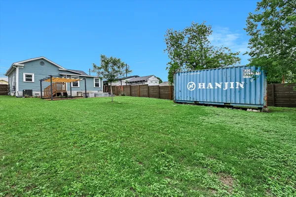a view of a house with a yard and sitting area