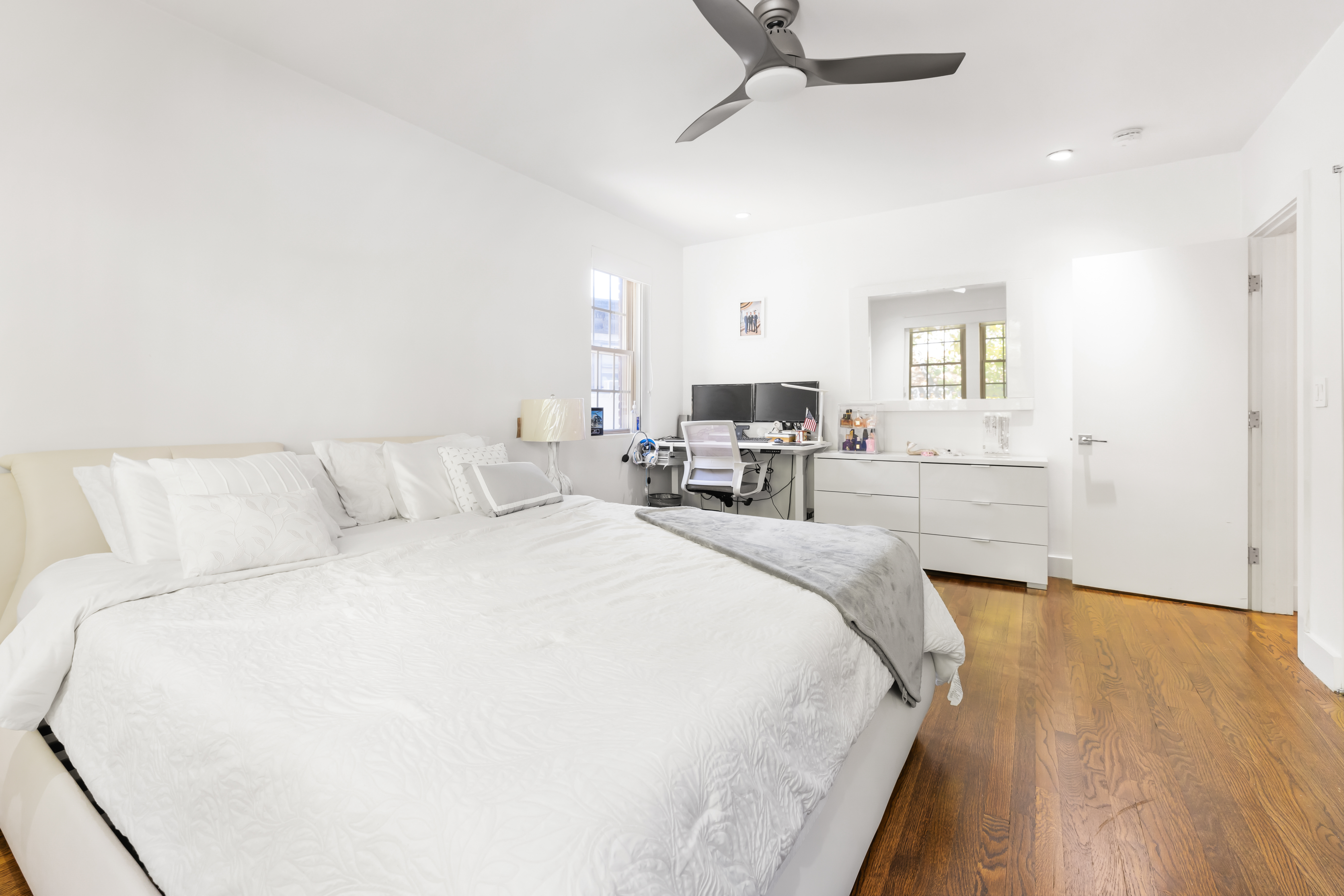 1490 Beacon Street, Unit 4 Brookline, MA 02446 - Photo 18 of 20 a spacious bedroom with a bed a couch and a window