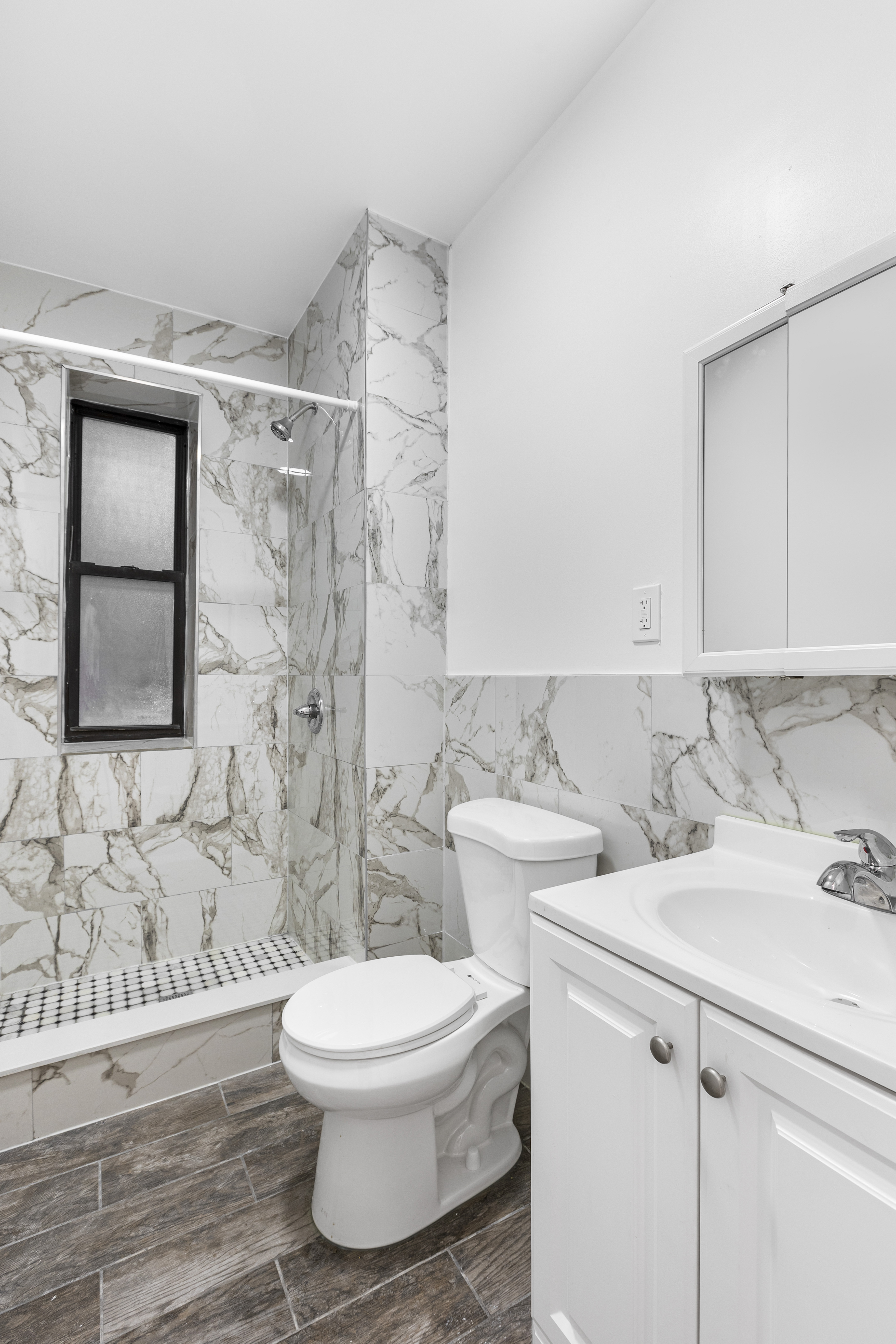 214 East 82nd Street, Unit 5 Manhattan, NY 10028 - Photo 2 of 2 a bathroom with a sink toilet and shower