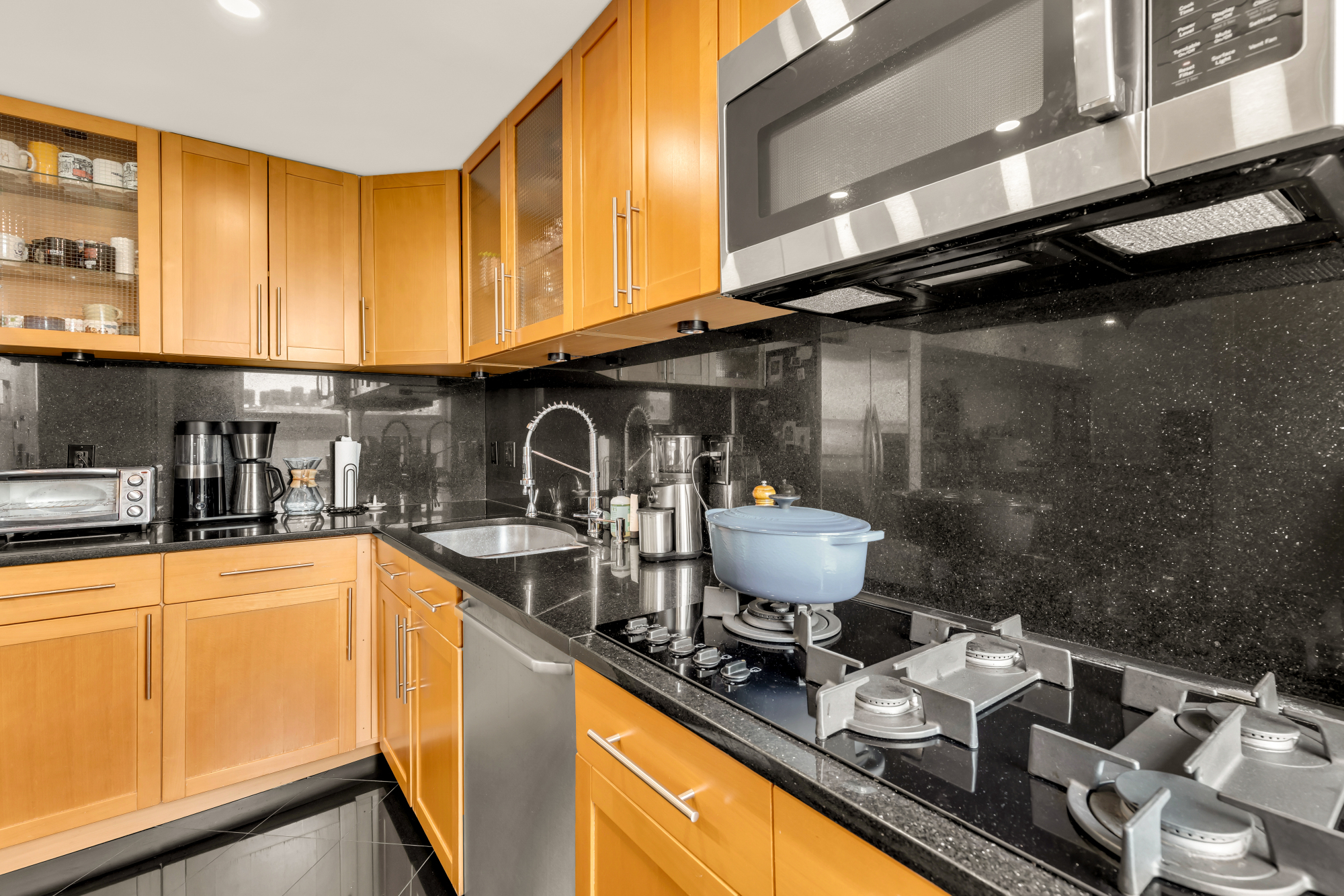 2127 California Street Northwest, Unit 505 Washington, DC 20008 - Photo 22 of 40 a kitchen with stainless steel appliances granite countertop a sink stove and cabinets