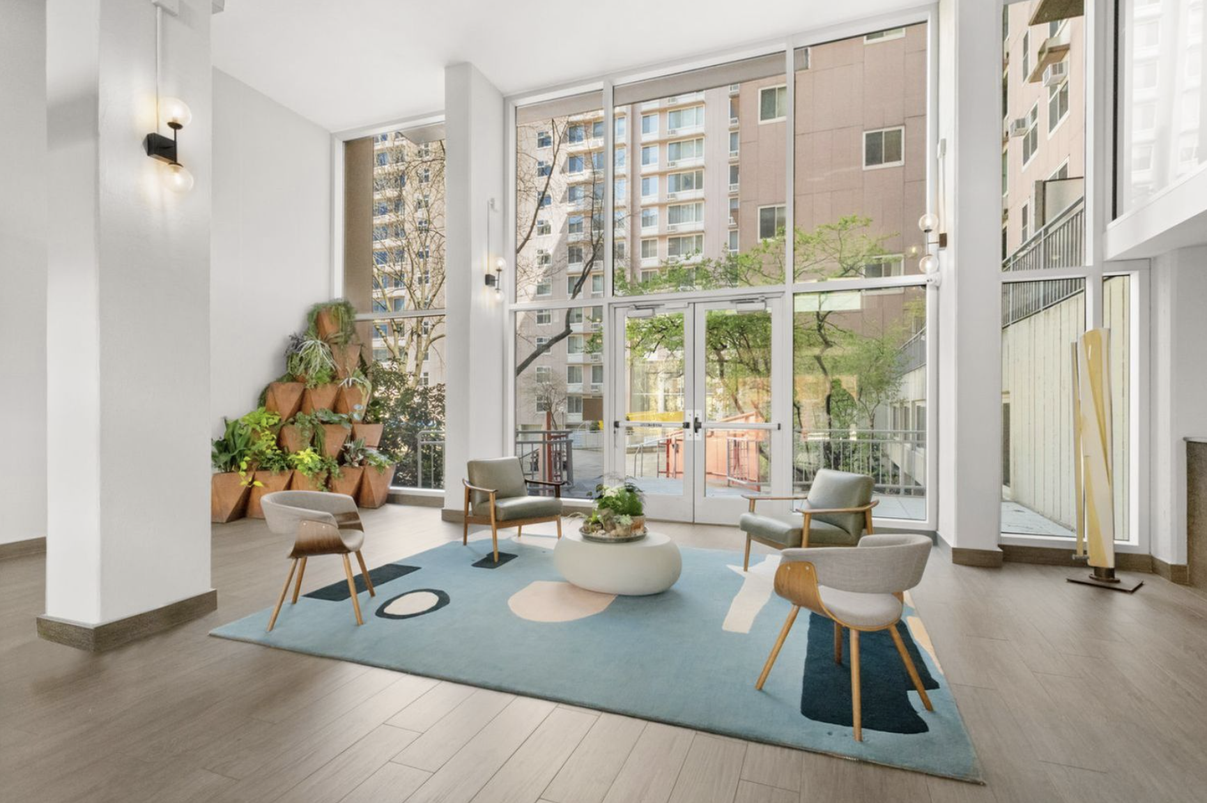 551 Main Street, Unit 208 Manhattan, NY 10044 - Photo 26 of 36 a living room with furniture and a large window