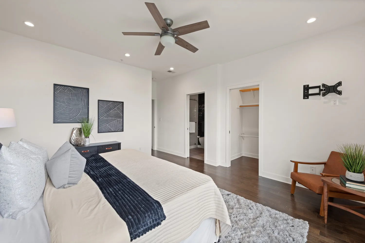 a bedroom with a bed a table and chair