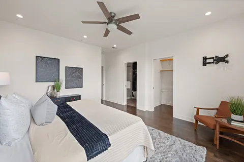 a bedroom with a bed a table and chair