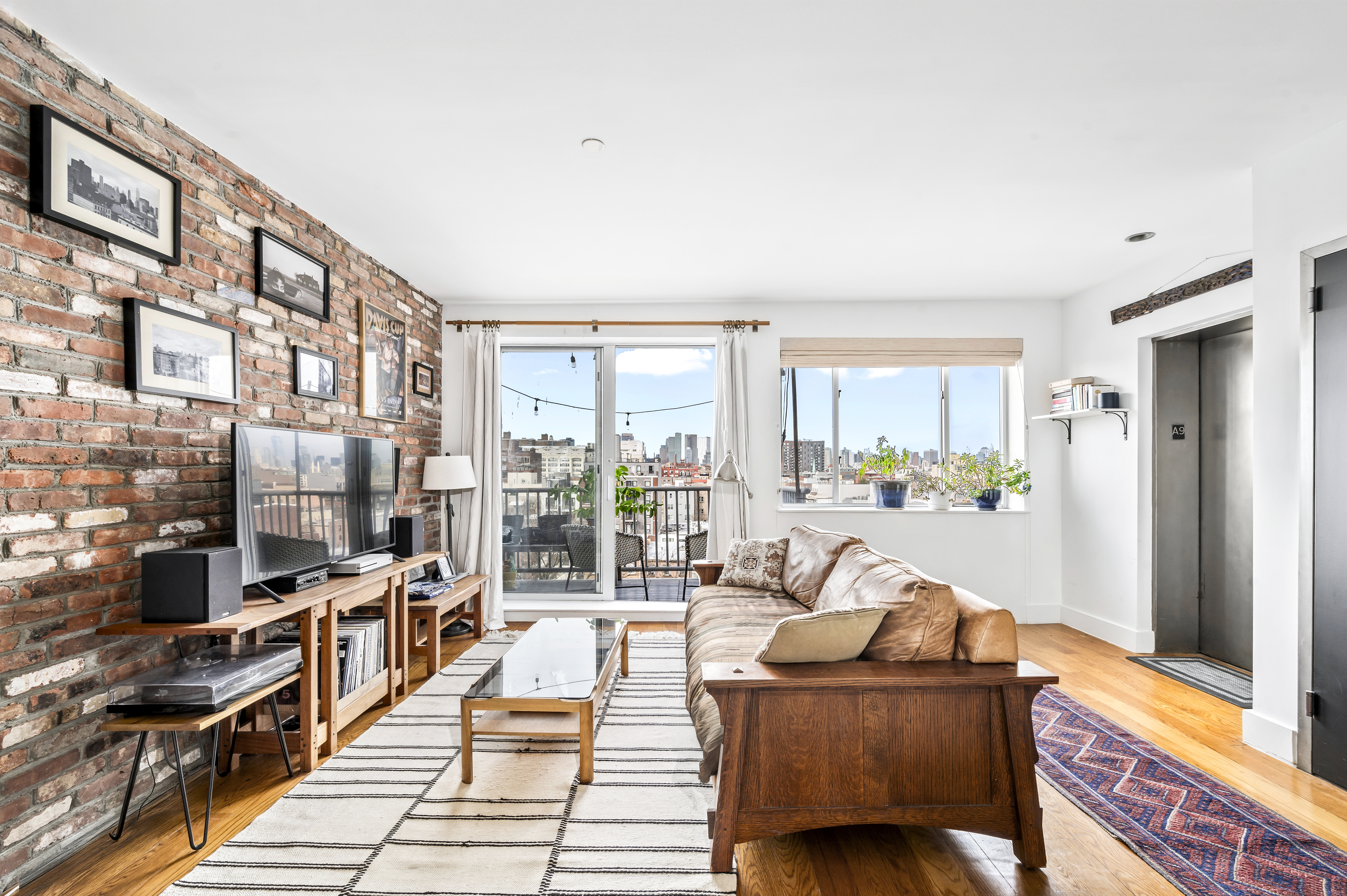 191 Spencer Street, Unit 9A Brooklyn, NY 11205 - Photo 1 of 10 a living room with furniture and a table
