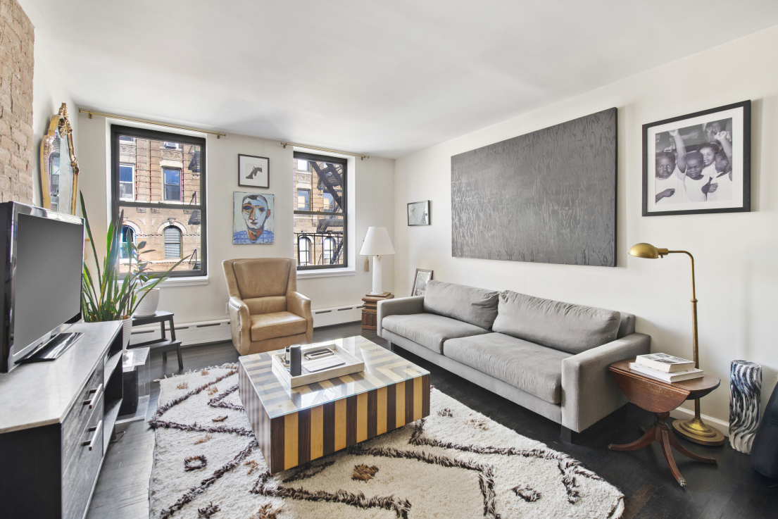 72 East 3rd Street, Unit 5A Manhattan, NY 10003 - Photo 3 of 16 a living room with furniture wooden floor and a flat screen tv